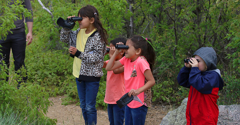 Children looking through binoculars at Cheyenne Mountain State Park. Copyright Kimmell.