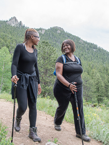 Two black women hike along a trail in Golden Gate State Park. Photo by Dustin Doskocil.