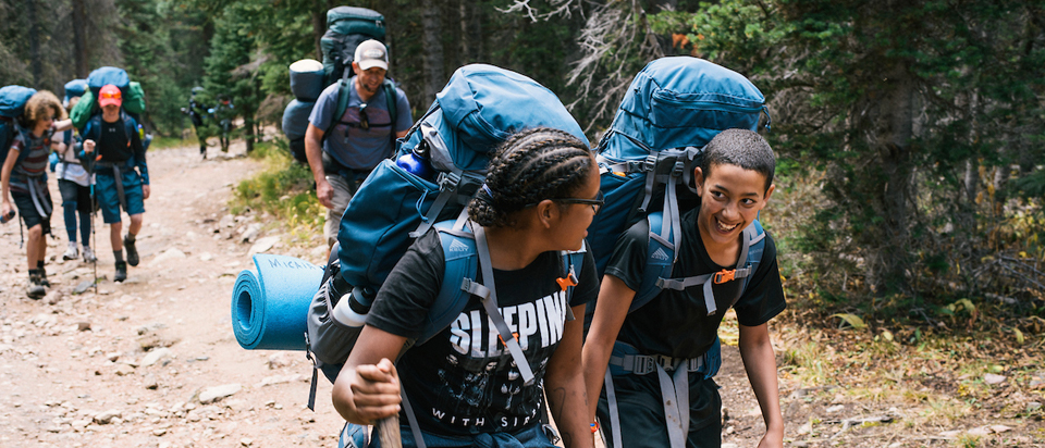 Image of two black youth leading their backpacking group at State Forest State Park.