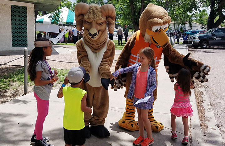 Mascots give high-fives to 4 children