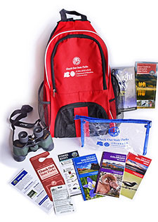 library backpack with items like birdwatching books, pencils and magnifiers