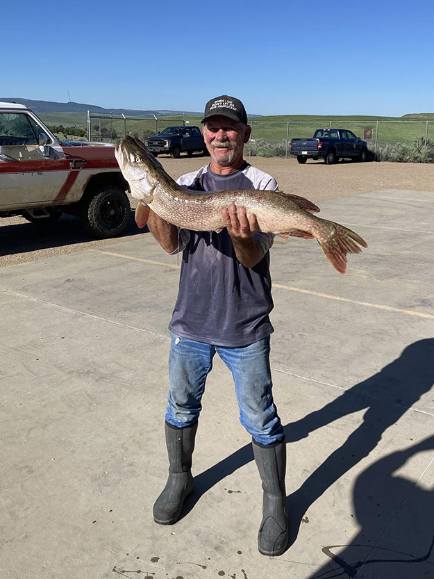 2023 Man Holding Large Pike caught in Elkhead Reservoir Tournament