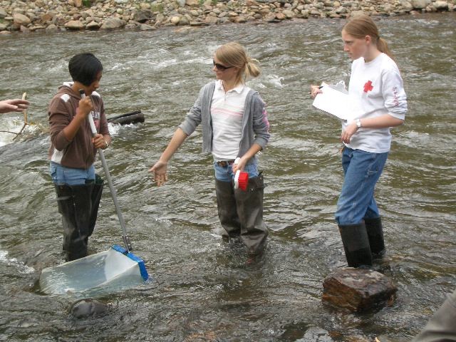 Youth collecting water samples in river