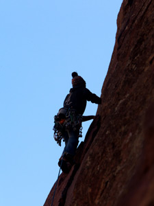 Woman climbing from below