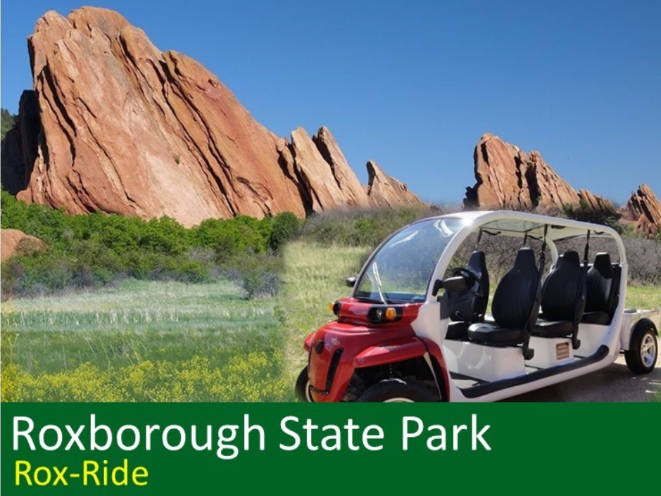 Extended electric golf cart in front of a field and large red rock formations