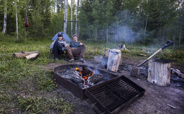 Couple and foresty campsite with firepit