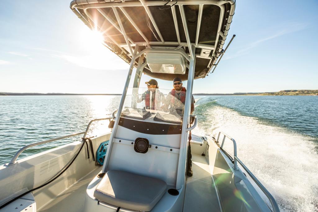 CPW enforcement officers in a boat on the water looking for people who are boating under the influence