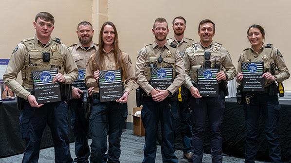 Left to right: Lifesaving Awardees: Chatfield Park Ranger Karsen Krier, Lake Pueblo Senior Ranger Daryl Sedar, Lake Pueblo Park Ranger Erin Steinman, Chatfield Park Ranger Tyler Hall, Chatfield State Park Ranger Timothy Abt, Cherry Creek Park Ranger Levi Reisinger and Chatfield State Park Ranger Kennedy Miller.