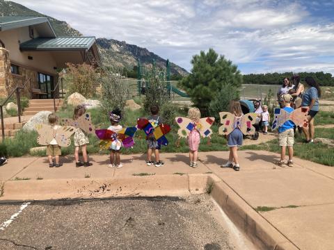 A group of children wearing crafted wings