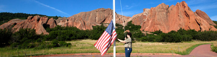 Parks staff raising US flag at Roxborough State park