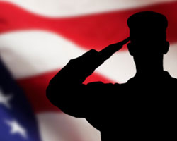 Sillouette of soldier saluting flag