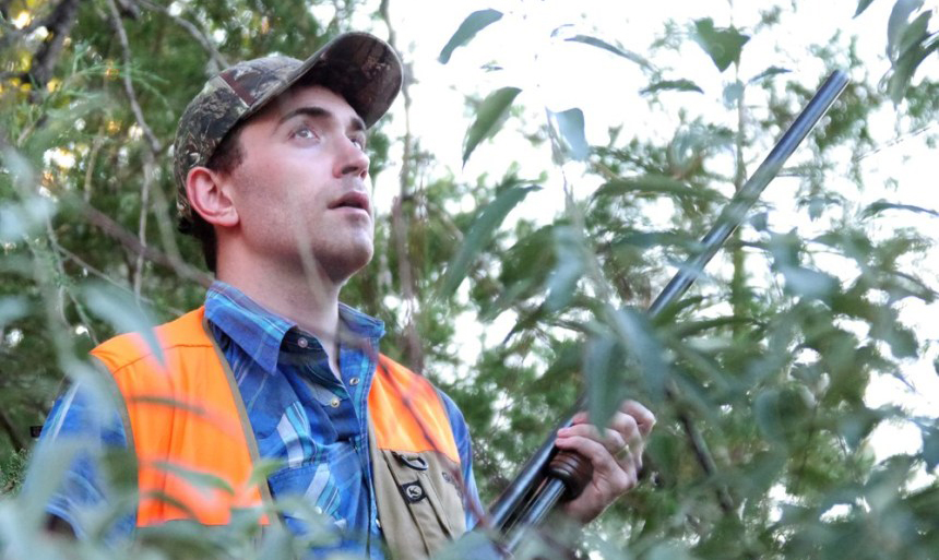 Hunter Kevn Lansing taking cover behind trees while dove hunting