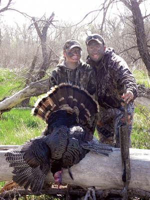 Hunting couple Jonathan and Kayla pose with her first bird. Photo by Johnathan Lambert.
