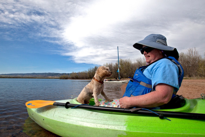 A small dog in a kayak with the owner.