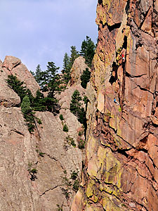 Two climbers on cliff-side of Eldorado Canyon State Park.