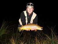 Fly Fisherman with Trophy Brown Trout