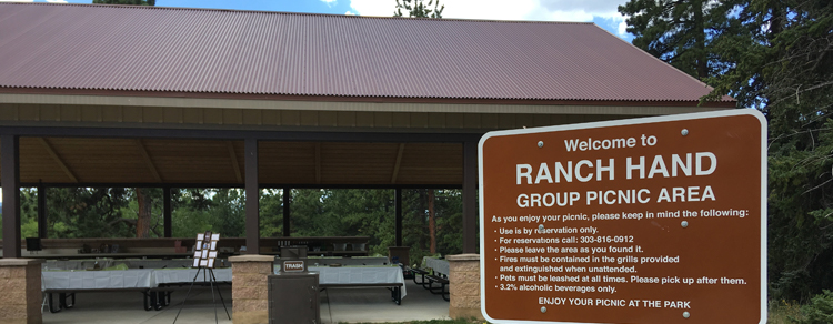 The Ranch Hand Picnic Area Pavilion with the sign in the foreground.